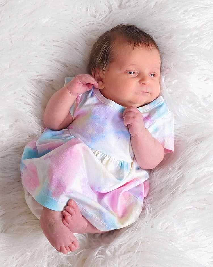 Winter is registered to the contest to win money with this photo: baby, baby_toddler_clothing, cheek, child, chin, comfort, eye, flash_photography, head, iris, linens, lip, magenta, pattern, person, pink, sitting, skin, sleeve, stomach