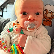 Kaïs participe au concours pour gagner de l'argent avec cette photo : baby, pacifier, rattle, toy, infant, closeup, face, hand, clothing, plush_toy, sheep, bear, cozy, cute, expression, indoor, person, child, newborn, soft