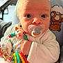 baby, pacifier, rattle, toy, infant, closeup, face, hand, clothing, plush_toy, sheep, bear, cozy, cute, expression, indoor, person, child, newborn, soft