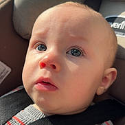 Bentley joined the competition — help win amazing prizes! baby, child, face, car_seat, seatbelt, blue_eyes, sweater, striped_clothing, button, close_up, indoors, infant, person, head, skin, expression, safety, seat, car, young
