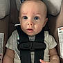 Bentley is registered to the contest to win money with this photo: baby, car_seat, child, infant, straps, seatbelt, curious, blue_eyes, padded, safety, close_up, cute, hand, clothing, white_shirt, portrait, indoor, infant_face, child_safety, secured