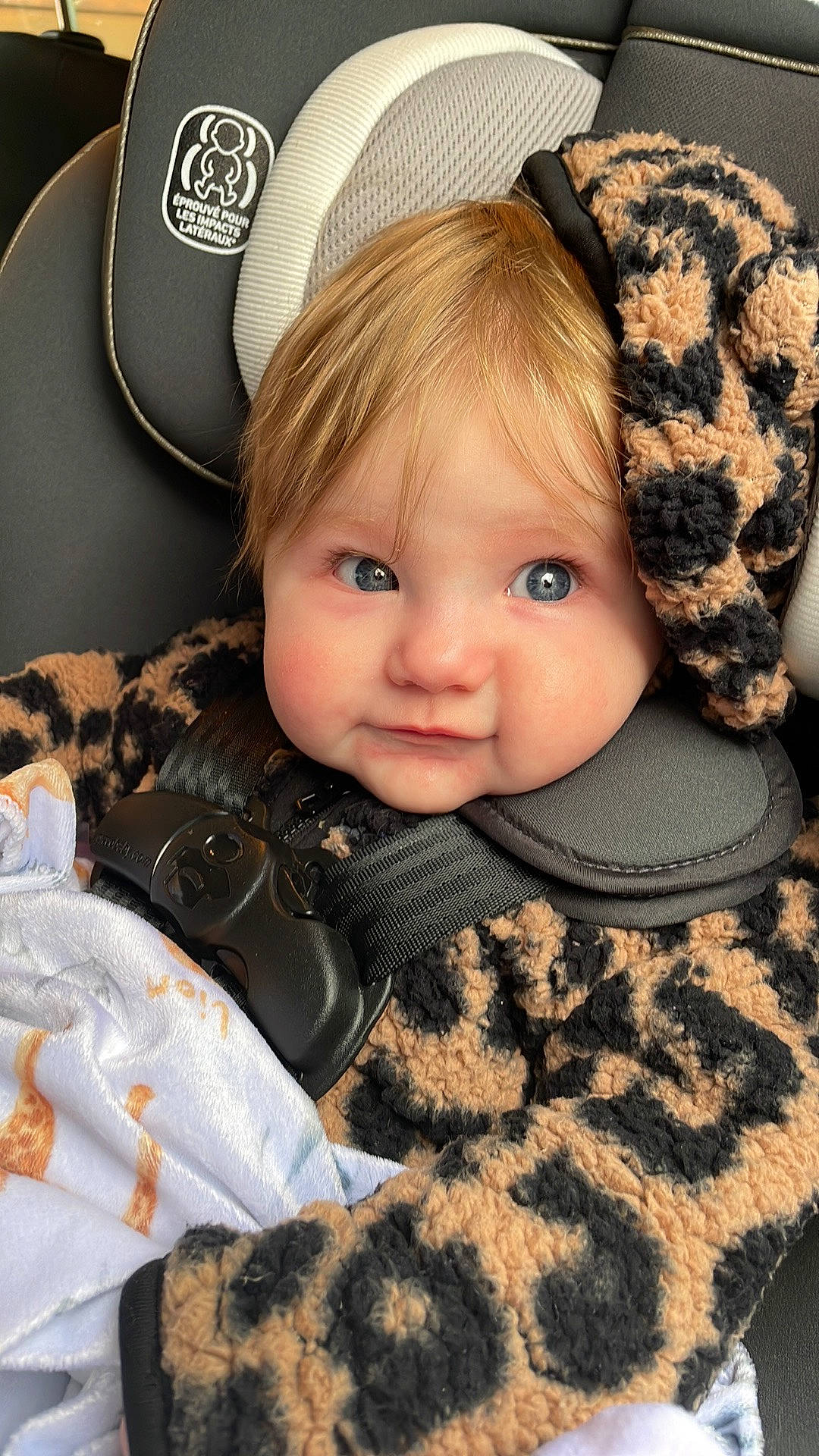 Leona is registered to the contest to win money with this photo: baby, baby_toddler_clothing, cap, cheek, child, comfort, costume_hat, eyelash, face, fur_clothing, happy, hat, headgear, jacket, outerwear, pattern, person, skin, sleeve, textile