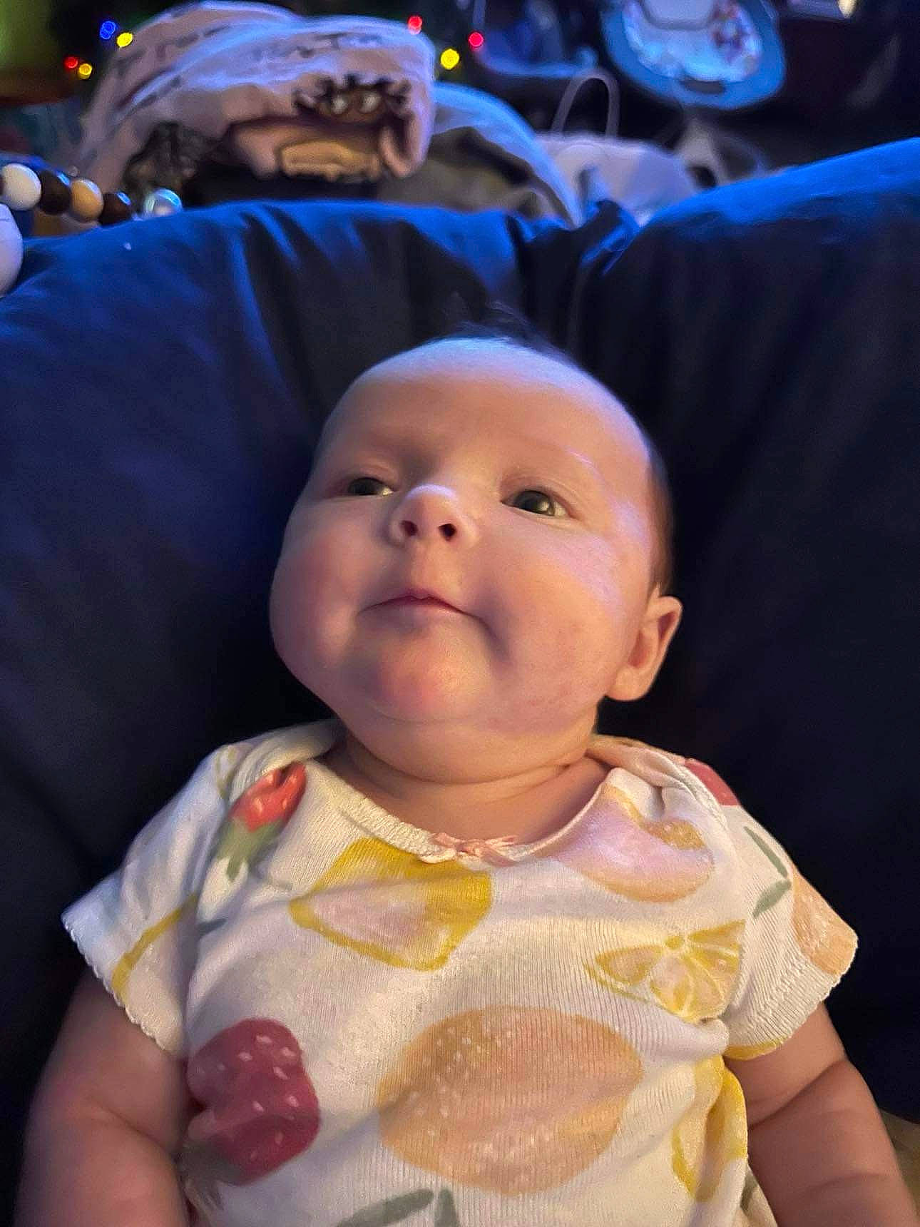 Kinzley joined the competition — help win amazing prizes! baby, baby_products, baby_toddler_clothing, bib, cheek, child, dress, event, fun, happy, holiday, peach, person, sitting, smile, toddler, vacation