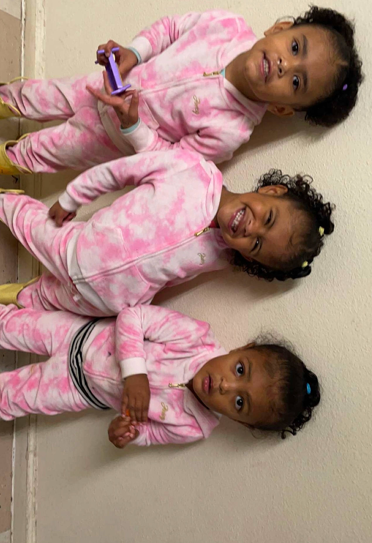 Cataleya is registered to the contest to win money with this photo: baby, baby_toddler_clothing, cheek, child, comfort, flooring, foot, fun, hair, happy, joy, magenta, nightwear, pattern, person, pink, sitting, skin, sleeve, smile