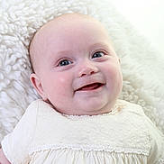 Lua Mary Janet Ellis joined the competition — help win amazing prizes! baby, infant, smiling, white_dress, fluffy_blanket, portrait, face, cute, child, happy, closeup, soft_texture, young, lying_down, indoors, skin, head, eyes, expression, small_person