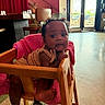 Symphony joined the competition — help win amazing prizes! baby, child, high_chair, wooden_chair, pink_blanket, indoor, curly_hair, clothing, foot, face, person, furniture, floor, door, glass, daylight, curtain, staircase, earrings, expression