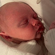 Gracelynn is registered to the contest to win money with this photo: baby, newborn, sleeping, pacifier, blanket, white_clothing, infant, closeup, face, peaceful, soft_light, indoors, cute, resting, skin, head, mouth, ear, toddler, cozy