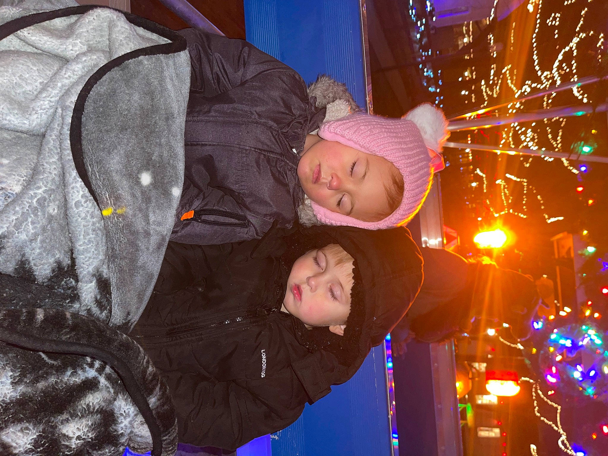 Mia is registered to the contest to win money with this photo: beauty, christmas_decoration, electricity, event, fun, happy, headwear, interaction, jacket, light, ornament, outerwear, person, photograph, plant, sky, snapshot, toddler, tree, window