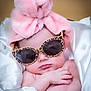 baby, infant, sunglasses, pink_towel, turban, leopard_print, fabric, silk, wrapped, cute, face, hand, relaxing, sleepy, indoor, portrait, child, fashion, accessory, headwear