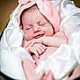 Willow is registered to the contest to win money with this photo: baby, infant, smile, sleeping, pink_headband, soft_fabric, blanket, cute, newborn, portrait, peaceful, indoors, closeup, happy, child, resting, skin, small_hands, cozy, tender