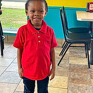 Rex is registered to the contest to win money with this photo: black_pants, casual_clothing, chairs, child, daylight, floor, happy, indoors, interior, person, polo_shirt, portrait, red_shirt, smiling, standing, teal_wall, tiles, window, yellow_wall, young