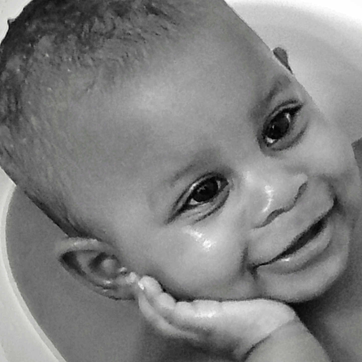Moxie is registered to the contest to win money with this photo: baby, black_and_white, cheek, child, close_up, cute, ear, expression, eyes, face, hand, happy, head, innocence, joy, person, portrait, skin, smiling, young_child