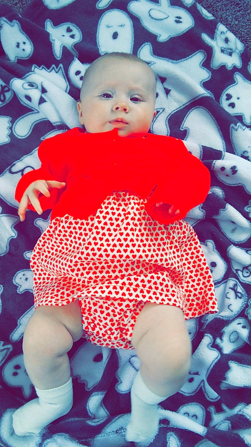 June joined the competition — help win amazing prizes! baby, baby_products, baby_toddler_clothing, cheek, child, design, head, pattern, person, pink, product, red, sitting, skin, sleeve, textile, toddler