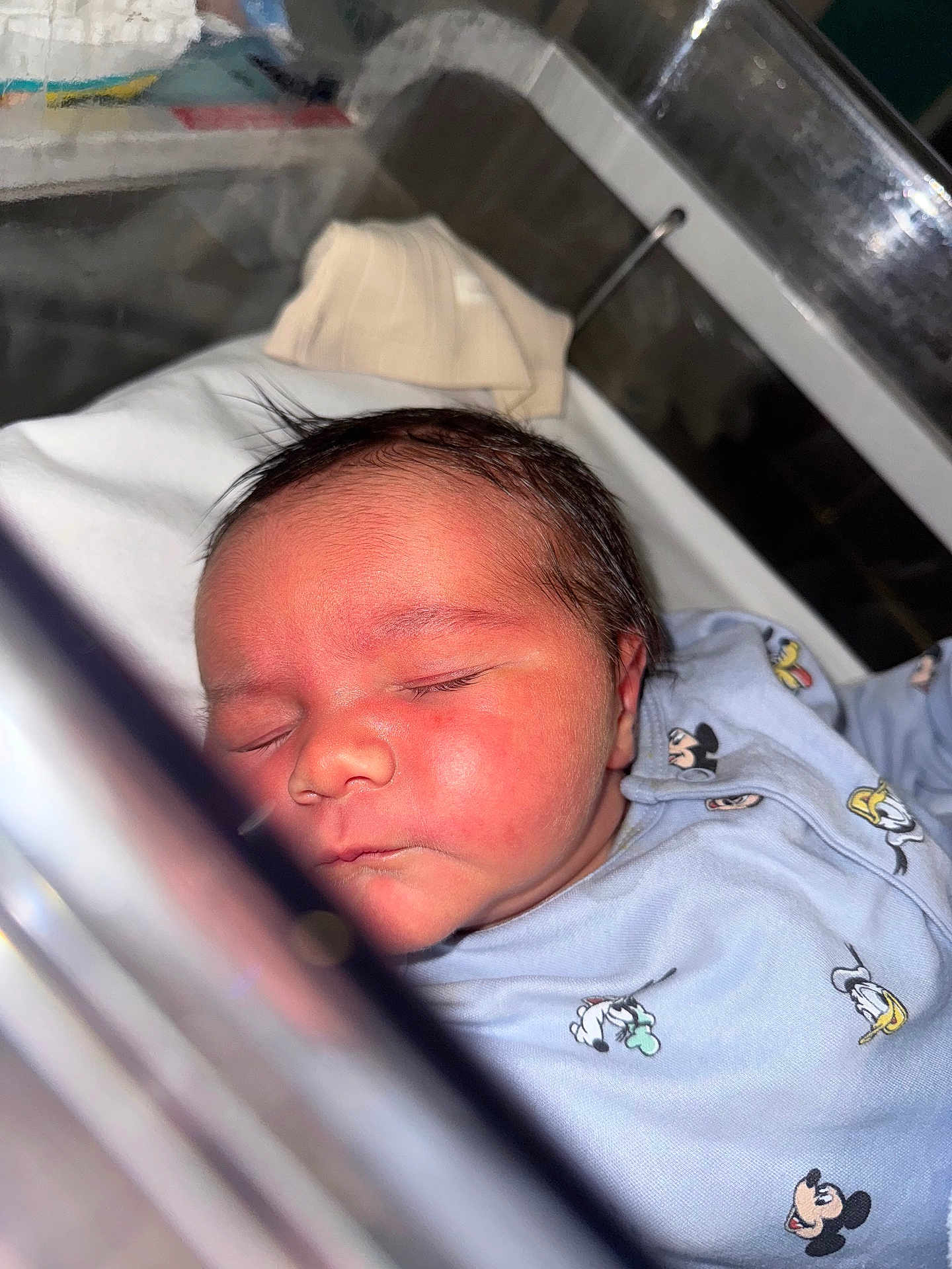 Harrison joined the competition — help win amazing prizes! baby, bassinet, child, closed_eyes, clothing, cute, face, hospital, indoors, infant, mickey_mouse, newborn, onesie, peaceful, portrait, rest, skin, sleeping, soft_lighting, young