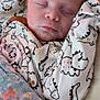 Lucian joined the competition — help win amazing prizes! baby, sleeping, onesie, dinosaur_pattern, blanket, floral, infant, peaceful, cute, child, face, closed_eyes, soft_lighting, indoor, portrait, newborn, rest, comfort, cozy, young