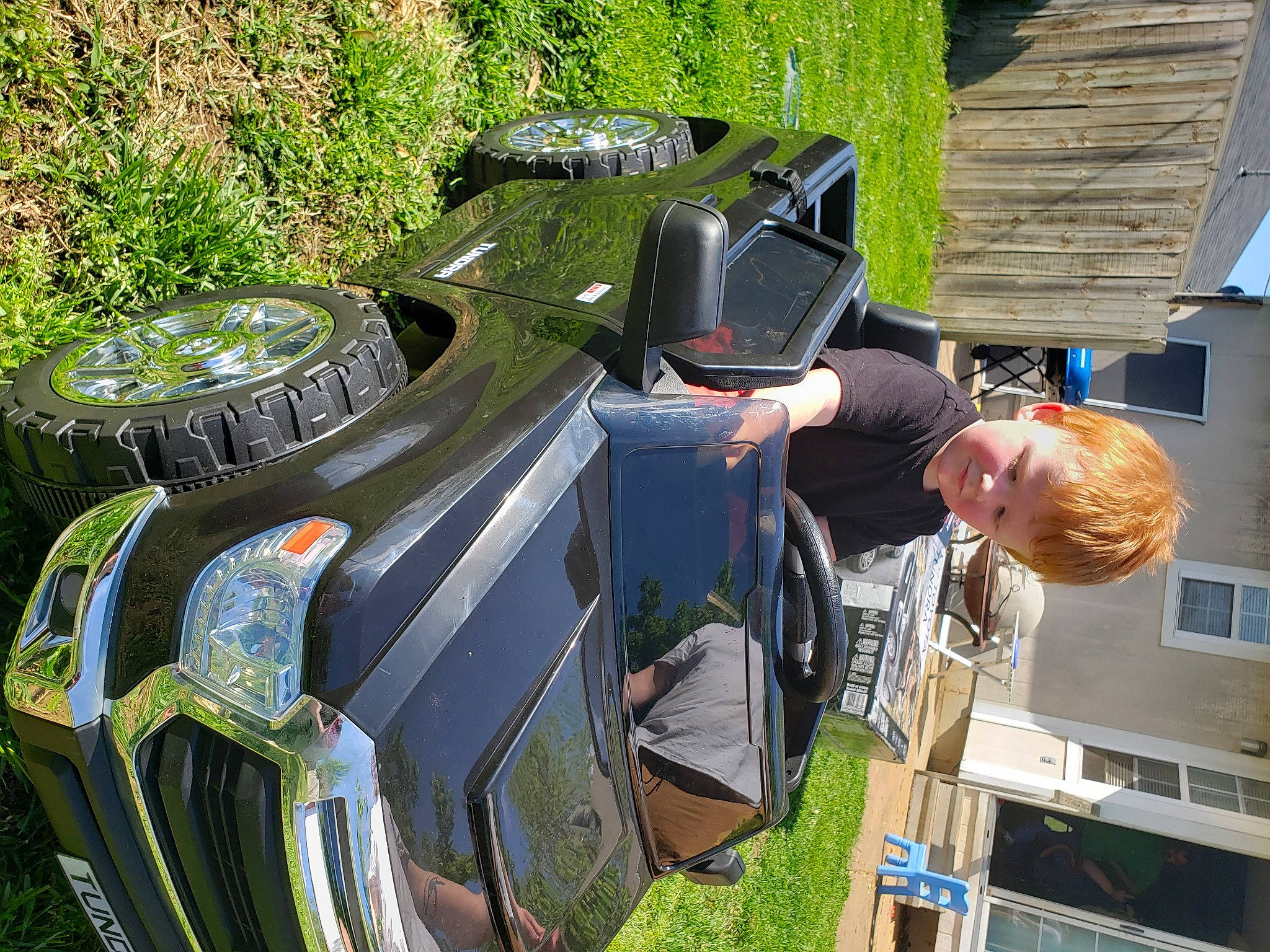 Kaidyn joined the competition — help win amazing prizes! automotive_exterior, car, games, motor_vehicle, person, tree, vehicle