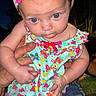 baby, child, blue_eyes, headband, floral_pattern, colorful_clothing, denim_shorts, holding_hands, outdoor, nighttime, person, cute, infant, skin, expression, small_hands, portrait, vibrant, fashion, human
