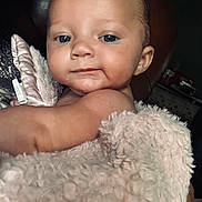 Allie is registered to the contest to win money with this photo: baby, infant, child, face, blue_eyes, blanket, pink_blanket, skin, close_up, portrait, cute, soft_texture, indoor, person, newborn, expression, warm, comfort, resting, young