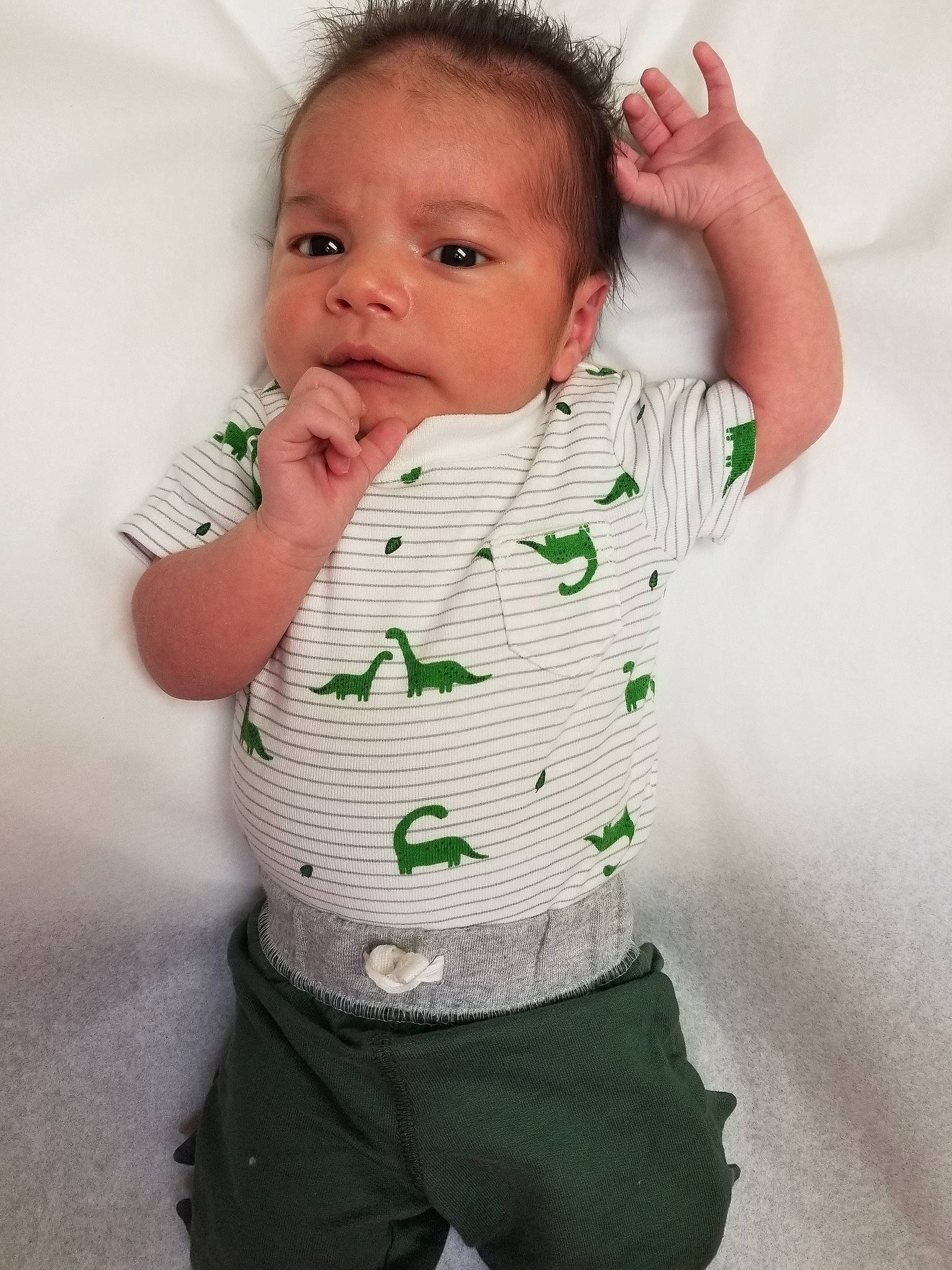 Kaison is registered to the contest to win money with this photo: arm, baby, baby_toddler_clothing, cheek, child, green, neck, person, sleeve, standing, toddler