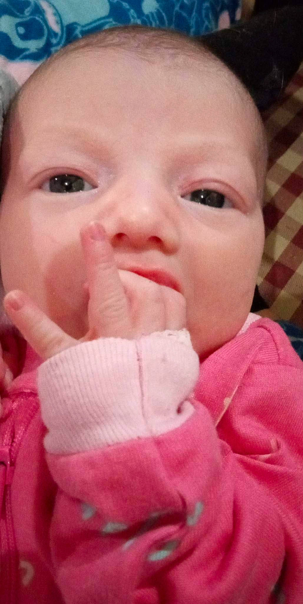 Everleigh is registered to the contest to win money with this photo: baby, baby_toddler_clothing, cheek, clothing, ear, eyebrow, eyelash, finger, gesture, hand, happy, lip, mouth, nail, nose, person, pink, skin, sleeve, thumb