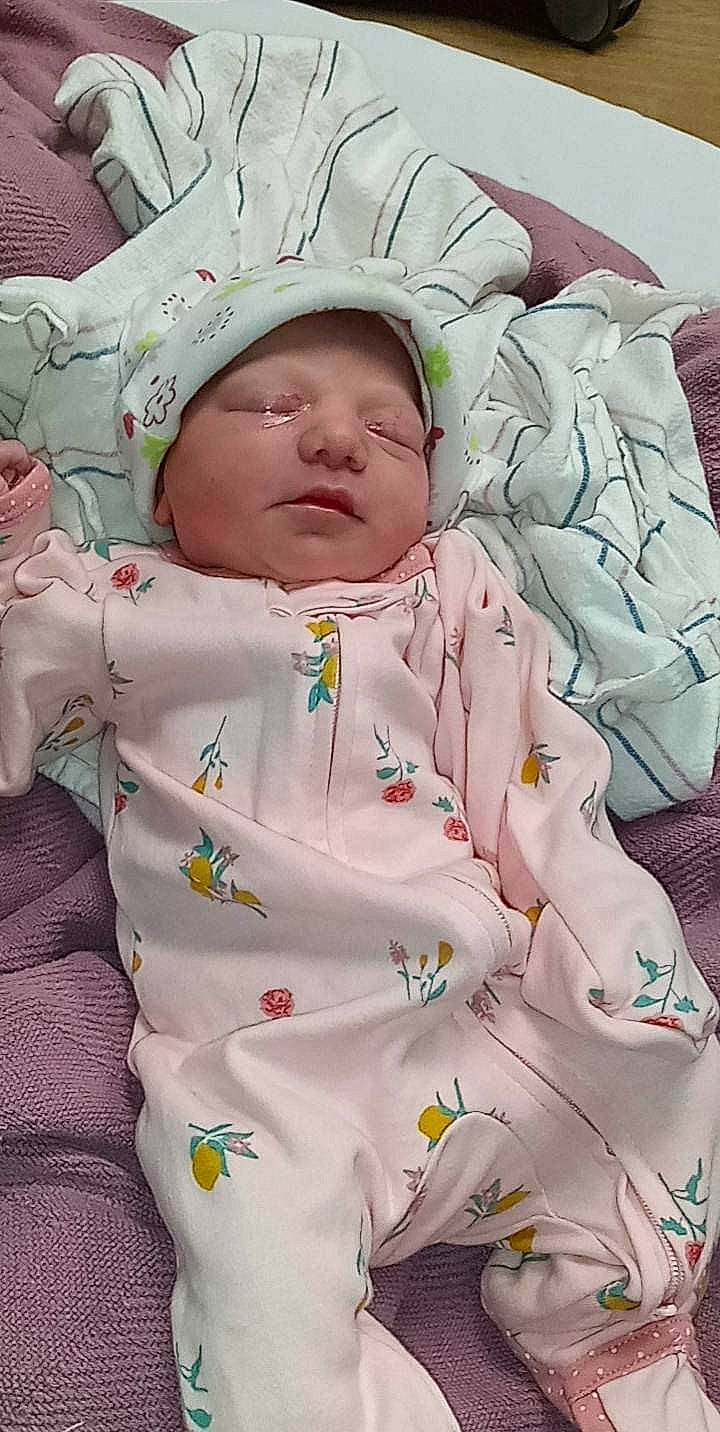 Everleigh is registered to the contest to win money with this photo: baby, baby_products, baby_sleeping, baby_toddler_clothing, bedding, bedtime, cheek, child, comfort, eye, hat, human_body, linens, peach, person, pink, room, skin, sleep, sleeve