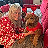 Toby Broadwater joined the competition — help win amazing prizes! woman, person, two_dogs, dog, pet, cuddling, smiling, portrait, indoor, bedroom, bed, blanket, red_clothing, heart_decoration, valentines_day, brown_dog, curly_fur, small_dog, seated, home_decor