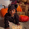 toddler, child, costume, mouse, halloween, pumpkin, hay_bale, balloon, face_paint, crawling, floor, holiday, festive, decoration, party, cute, black_clothing, orange_pumpkin, background, indoors