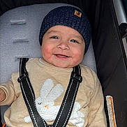 Alec Leal joined the competition — help win amazing prizes! baby, smiling, child, hat, knit_hat, sweater, bunny_design, stroller, seatbelt, happy, cute, infant, bundle_up, outdoor, face, childrens_clothing, portrait, warm_clothing, seat, baby_seat
