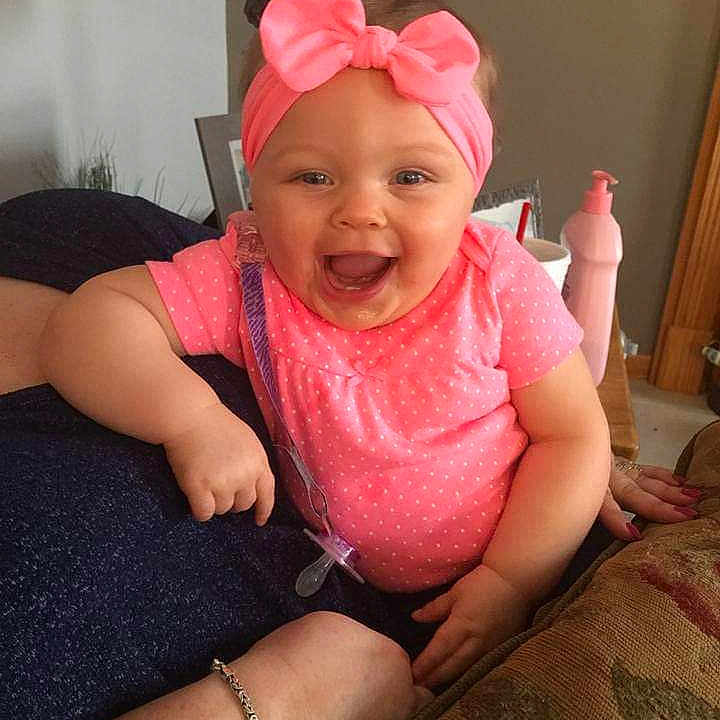 Nevaeh joined the competition — help win amazing prizes! accessories, baby, bracelet, clothing, couch, cushion, face, furniture, happy, head, homedecor, indoors, jewelry, lamp, lighting, necklace, person, photography, portrait, t_shirt