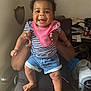 Robyn joined the competition — help win amazing prizes! adult, baby, barefoot, blanket, bow, chair, child, denim_shorts, desk, hands, happy, indoor, mickey_mouse_cup, nail_polish, papers, person, pink_bib, room, smiling, striped_shirt