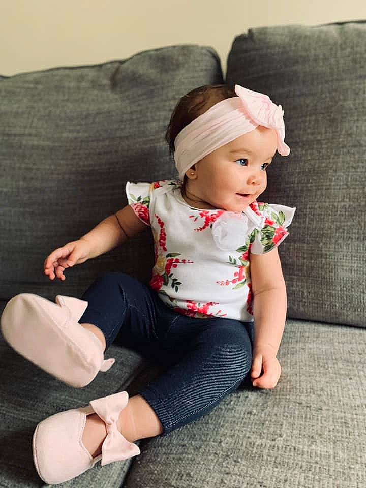 Abrielle is registered to the contest to win money with this photo: arm, baby, baby_toddler_clothing, child, child_model, clothing, footwear, headgear, joint, joy, leg, leggings, pattern, person, pink, product, sitting, skin, sleeve, tights