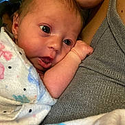 Myla joined the competition — help win amazing prizes! baby, infant, close_up, blanket, snuggling, face, expression, person, skin, human, newborn, comfort, cuddle, arm, head, sleepwear, indoor, warmth, love, family