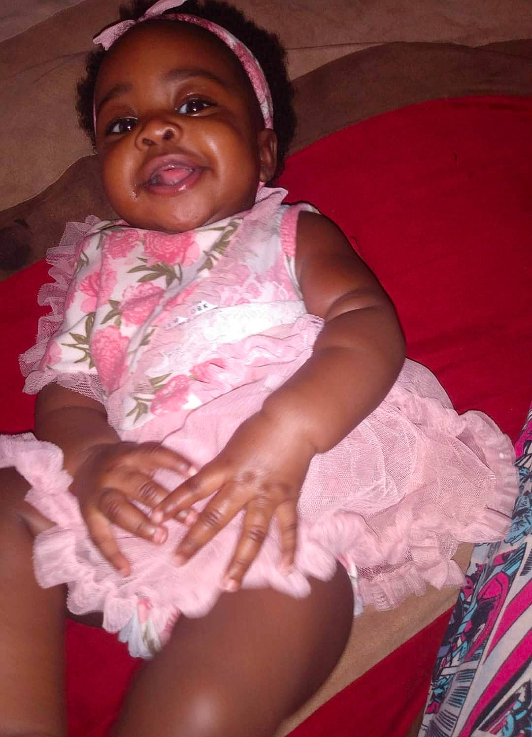 Ja'Kiaha is registered to the contest to win money with this photo: baby, baby_toddler_clothing, cheek, comfort, eye, eyebrow, facial_expression, finger, happy, human_body, lip, magenta, mouth, nose, person, pink, purple, skin, smile, thigh