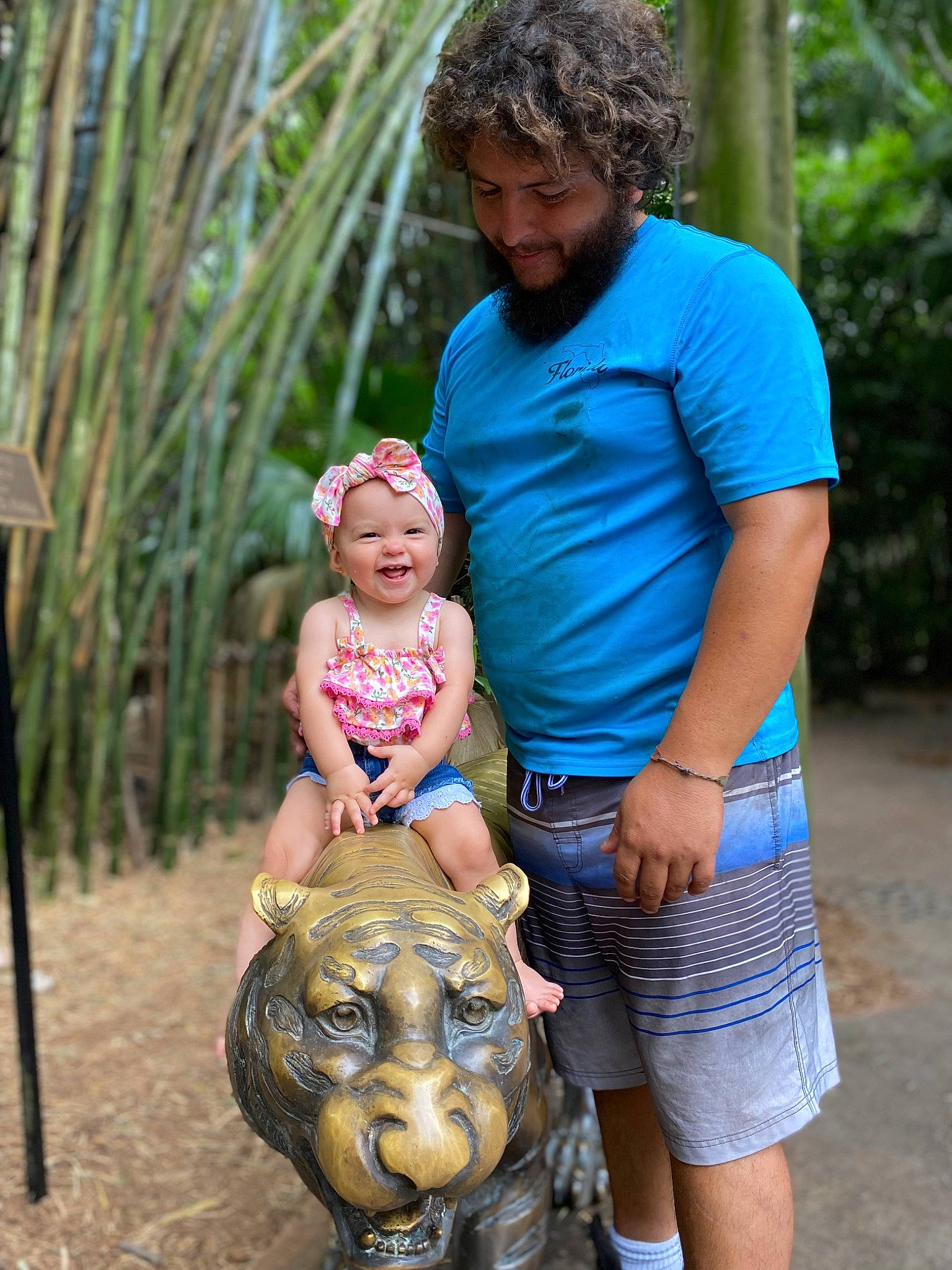 Raelynn is registered to the contest to win money with this photo: adaptation, art, child, eye, fawn, fun, grass, happy, head, headwear, joy, leisure, people, people_in_nature, person, plant, sculpture, shorts, skin, snout