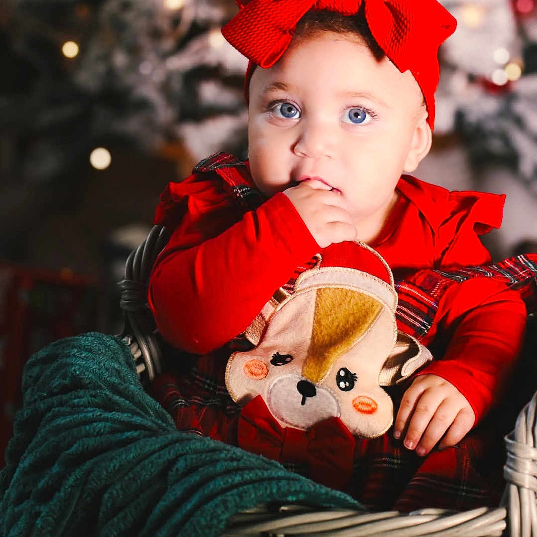 Myla is registered to the contest to win money with this photo: baby, basket, bodypart, cap, clothing, costume, couch, face, finger, furniture, hand, happy, hat, head, person, photography, portrait, smile, teddybear, toy
