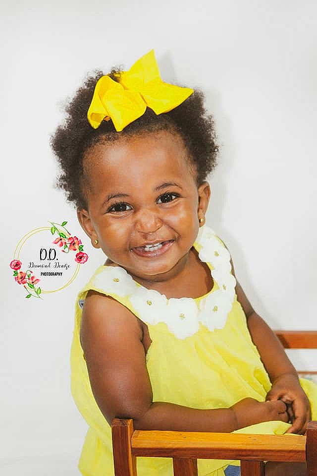 Layla is registered to the contest to win money with this photo: art, baby, baby_toddler_clothing, child, costume, hair, hair_accessory, hairstyle, happy, headband, headgear, joy, person, sitting, smile, toddler, yellow
