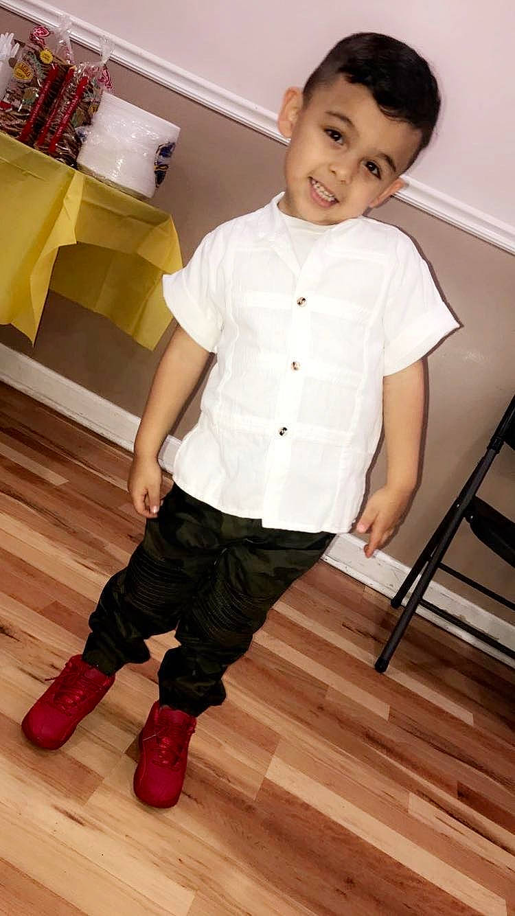 Thiago is registered to the contest to win money with this photo: abdomen, child, child_model, clothing, floor, flooring, footwear, joy, leg, outerwear, person, shoe, sleeve, standing, t_shirt, toddler, trunk, wood_flooring