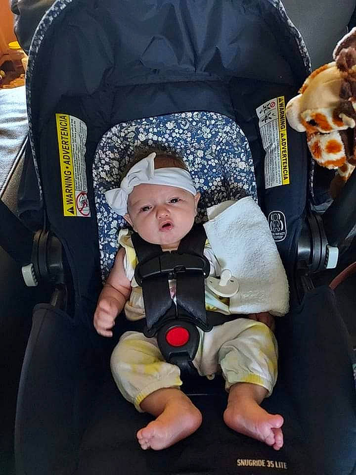 Lillian is registered to the contest to win money with this photo: auto_part, baby, baby_carriage, baby_in_car_seat, baby_products, baby_toddler_clothing, bag, cap, car_seat, child, comfort, fun, hat, headwear, person, personal_protective_equipment, photograph, product, sitting, toddler