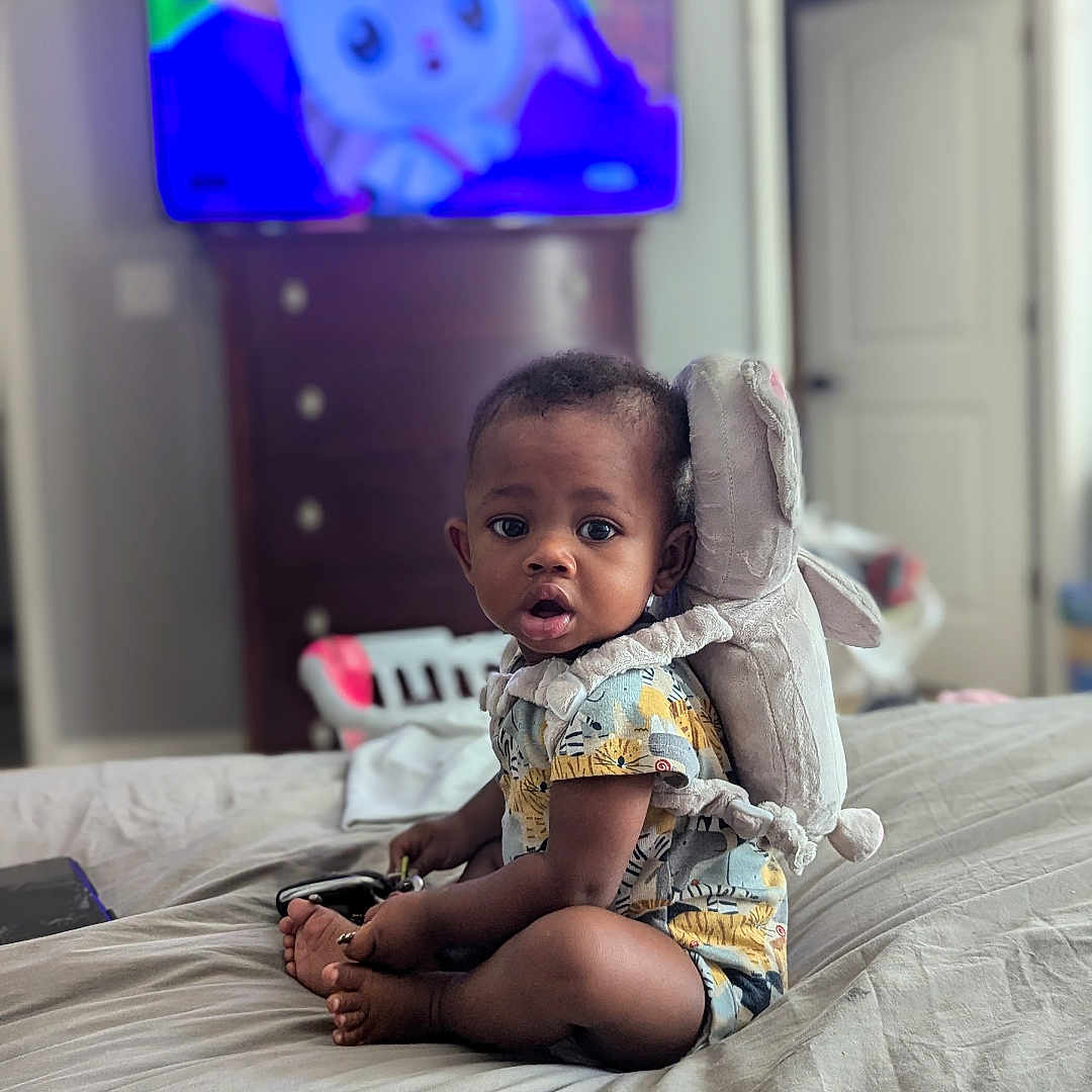 Carter joined the competition — help win amazing prizes! baby, bodypart, computerhardware, couch, cushion, electronics, face, finger, furniture, hand, hardware, head, homedecor, monitor, person, photography, portrait, screen, sitting, tv