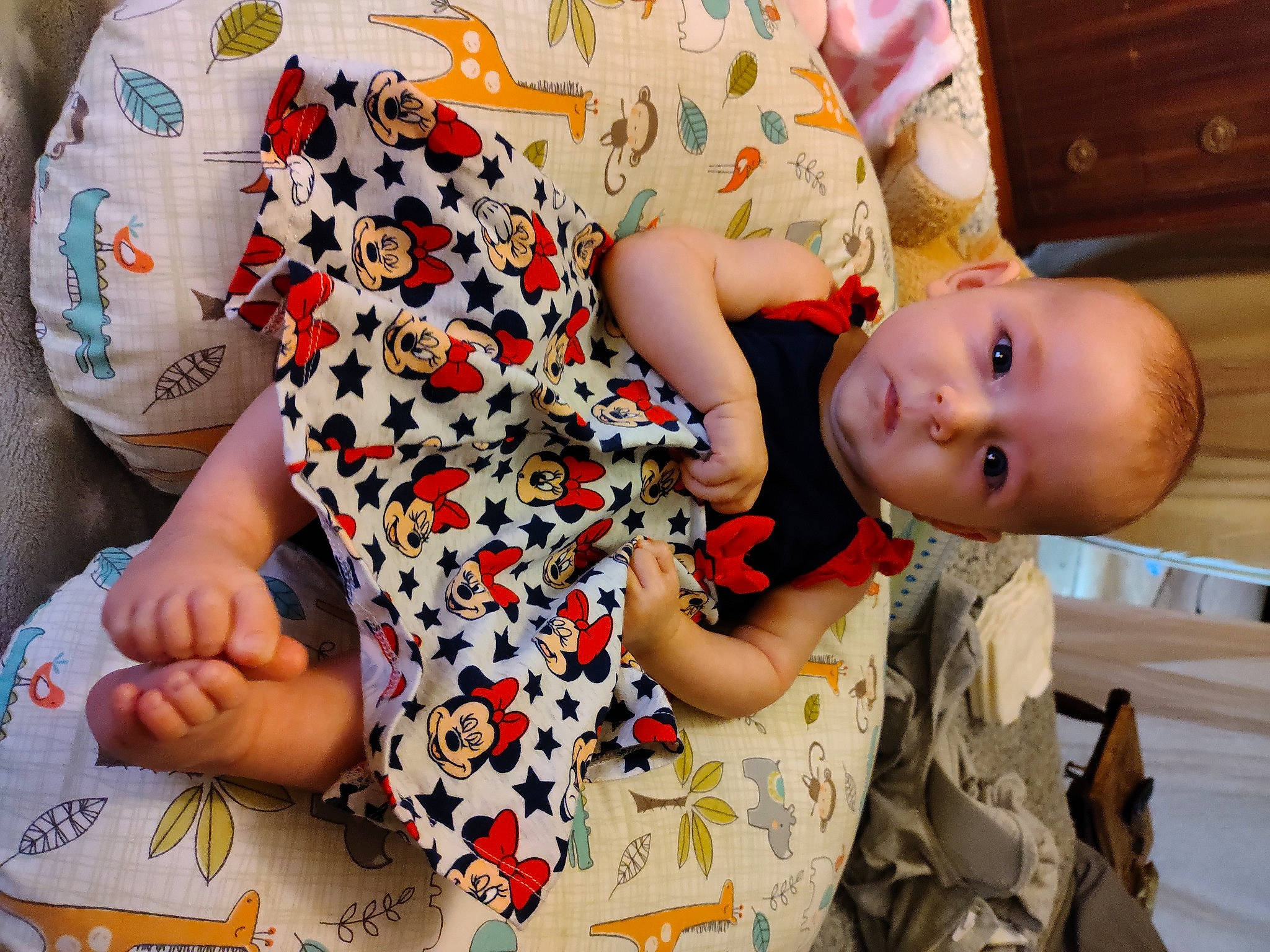 Lula is registered to the contest to win money with this photo: arm, baby, baby_toddler_clothing, child, comfort, facial_expression, finger, fun, gesture, hand, happy, joint, nail, pattern, person, sleeve, textile, thumb, toddler, wood