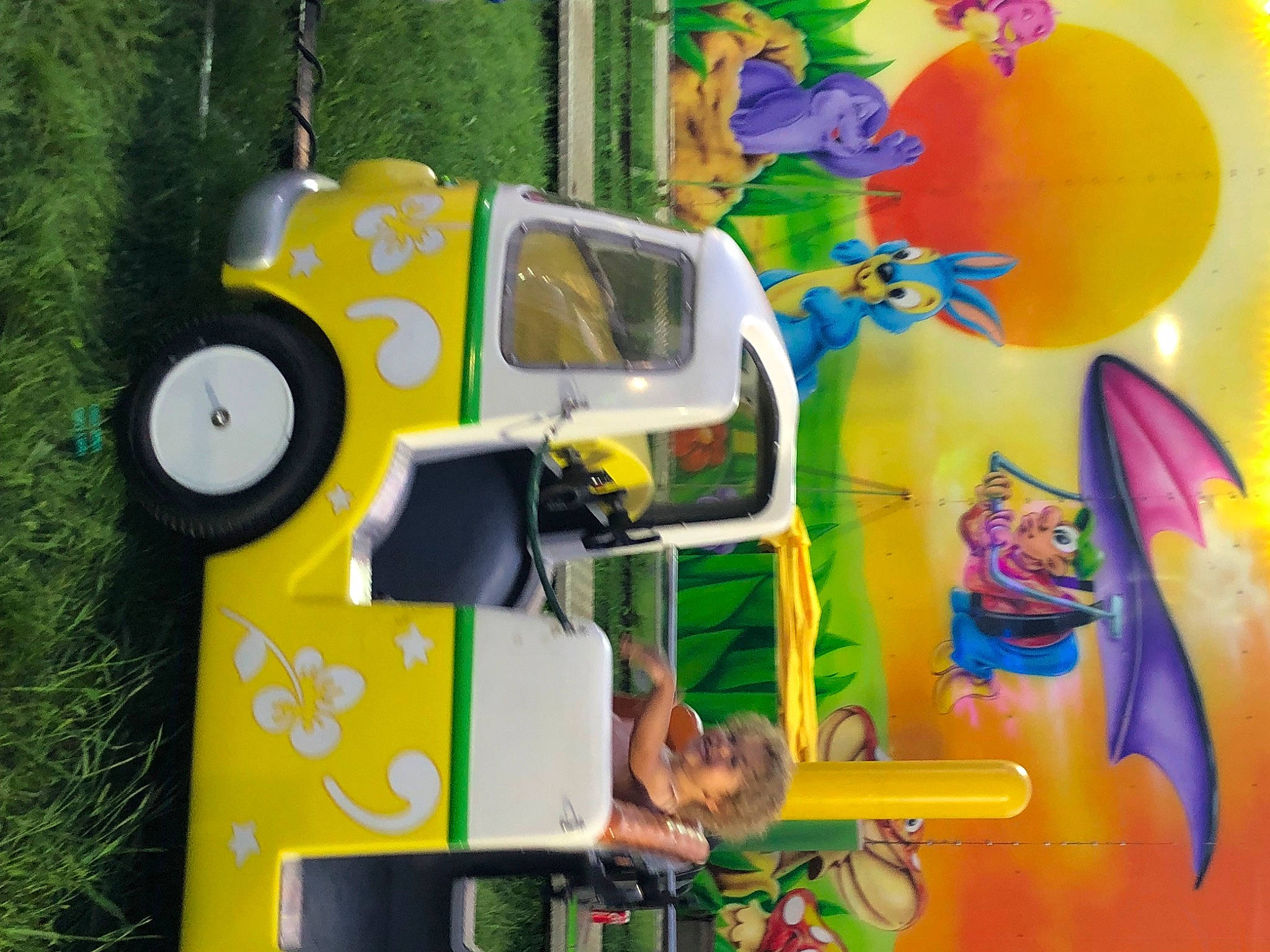 Skylar is registered to the contest to win money with this photo: animation, art, automotive_exterior, fun, grass, green, illustration, leisure, machine, motor_vehicle, paint, person, plant, plastic, recreation, shrub, toy, tree, visual_arts, wood