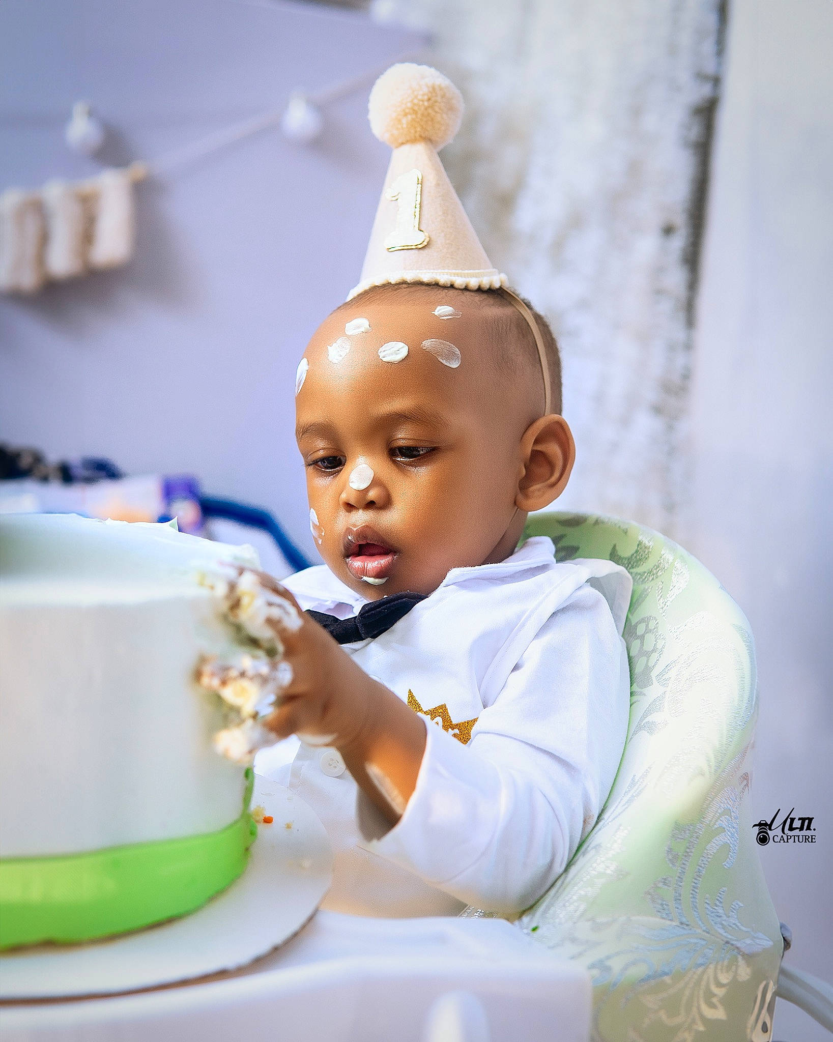 Kylian is registered to the contest to win money with this photo: baby, birthday, cake_decorating, child, cup, desk, dishware, drinkware, event, happy, icing, person, plate, porcelain, serveware, sitting, sweetness, table, tableware, teacup