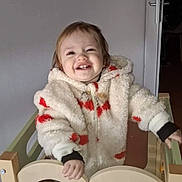 Julia participe au concours pour gagner de l'argent avec cette photo : baby, blocks, child, colorful, face, fluffy, gate, hand, happy, indoor, jacket, person, playpen, portrait, red, smiling, toddler, toy, white, wooden