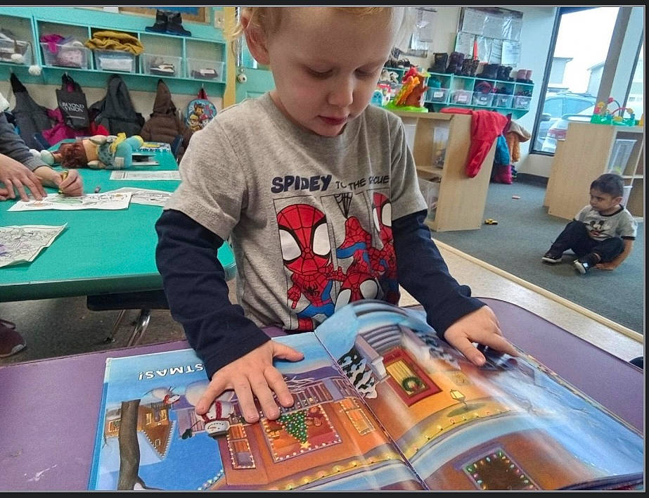 Oliver is registered to the contest to win money with this photo: adaptation, art, artist, chair, child, community, education, engineering, fun, indoor_games_and_sports, learning, leisure, person, play, publication, recreation, room, t_shirt, table, toddler