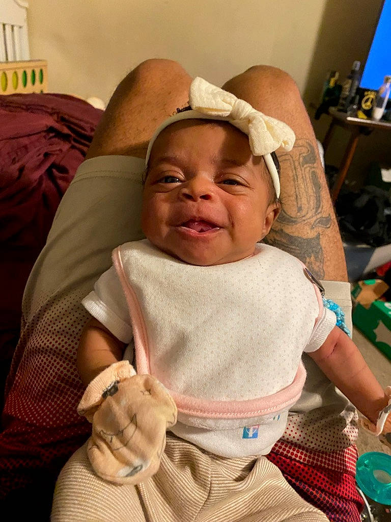 Allison is registered to the contest to win money with this photo: baby, baby_products, baby_toddler_clothing, cheek, child, comfort, event, finger, fun, happy, hat, head, linens, mouth, person, pink, room, skin, smile, thumb