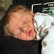 Charles participe au concours pour gagner de l'argent avec cette photo : newborn, baby, sleeping, blanket, teddy_bear, infant, face, peaceful, closeup, human, child, portrait, soft_lighting, cozy, warm, cute, resting, clothing, hoodie, person