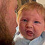 baby, infant, man, beard, face, closeup, expression, curious, blue_eyes, clothing, bib, indoor, portrait, parent, child, warmth, skin, hair, person, interaction