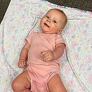 Adalynn is registered to the contest to win money with this photo: baby, infant, pink_onesie, blanket, floral_pattern, carpet, lying_down, smiling, child, cute, indoors, soft_lighting, happy, skin, face, hands, feet, head, person, portrait