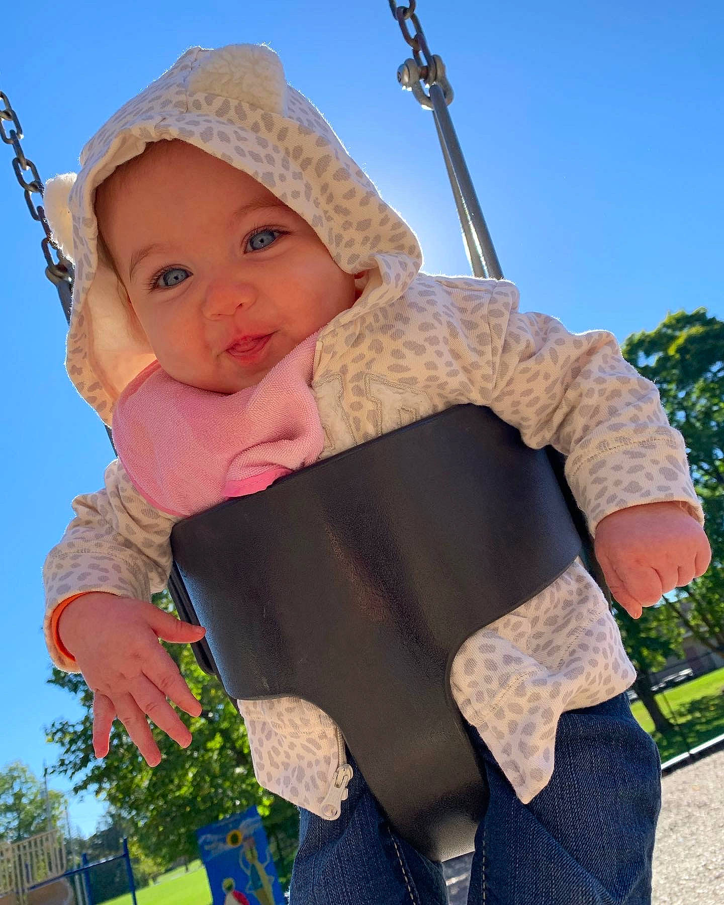 Harper joined the competition — help win amazing prizes! arm, baby, baby_toddler_clothing, blue, facial_expression, finger, grass, hand, happy, headgear, headwear, human_body, leisure, outerwear, people_in_nature, person, sky, sleeve, swing, toddler