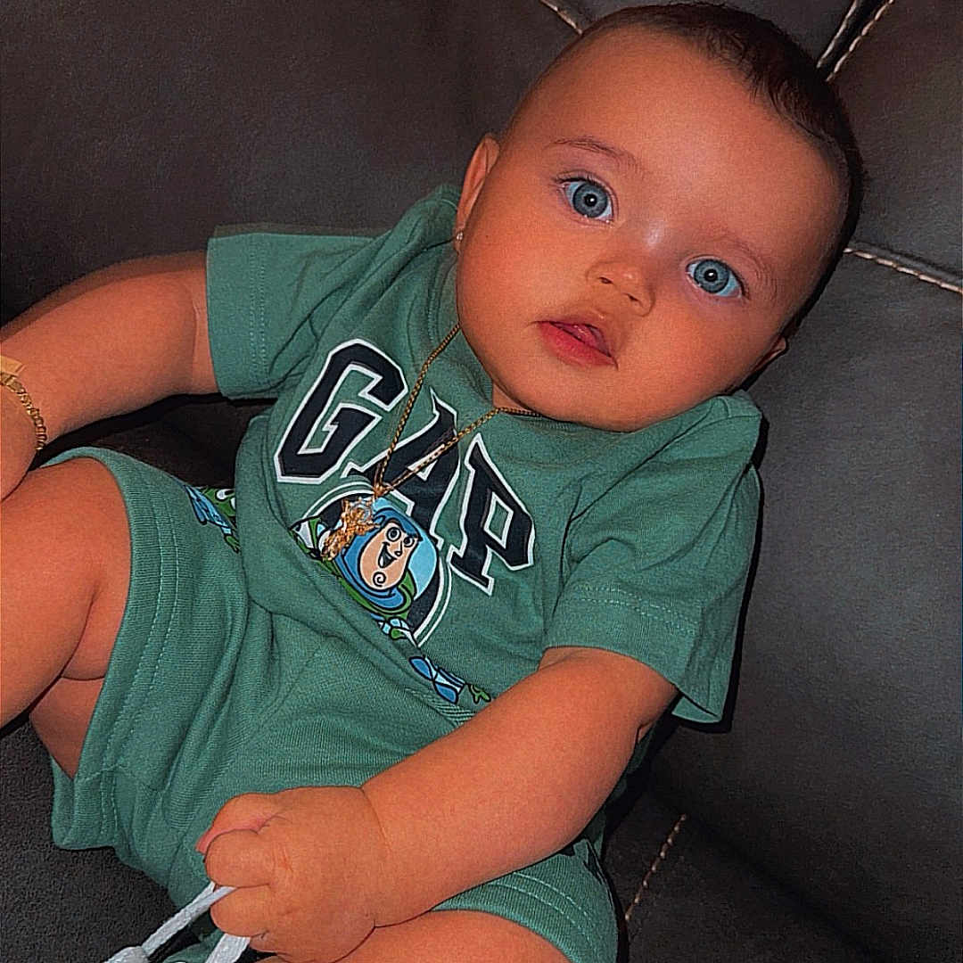 Phoenix joined the competition — help win amazing prizes! baby, blue_eyes, green_clothing, gap_logo, sneaker, white_shoes, leather_couch, blanket, child, cute, sitting, casual, indoor, portrait, infant, fashion, accessory, watch, bracelet, young